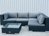 an image of a couch and coffee table in front of a building