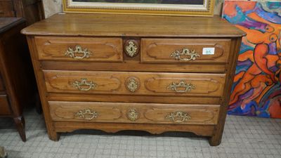 a picture of a dresser in a room with a painting on the wall