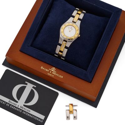 an image of a gold and silver watch in a gift box