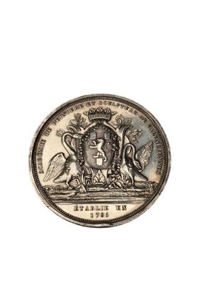 une image représentant une pièce d'argent sur laquelle figure un blason