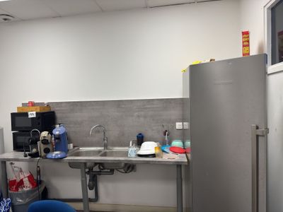 an image of a kitchen with a sink and a refrigerator