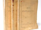 two old books sitting on top of each other on a white surface