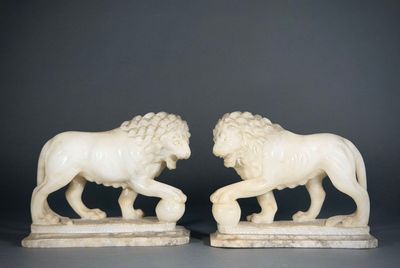 pair of carved ivory lions on marble bases