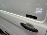 a close up of a white van with a clock on the door