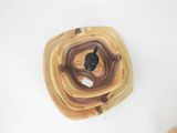 a wooden bowl with a black object in it