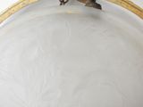 a glass plate with a gold rim and a bird on it