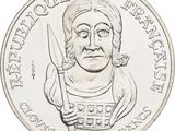 an image of a coin with a drawing of a woman holding a knife