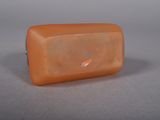 an orange soap bar sitting on top of a gray surface