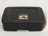 a black box with a sticker on it on a white surface