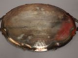 a silver tray with a handle on a table
