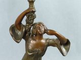 bronze statue of a woman holding a vase in her hand