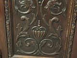 a wooden cabinet with ornate carvings on it
