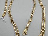 a gold chain necklace with a clasp and a clasp