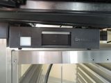 a close up of a metal object on a conveyor belt