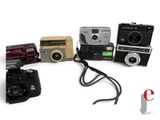 a lot of different types of cameras on the table