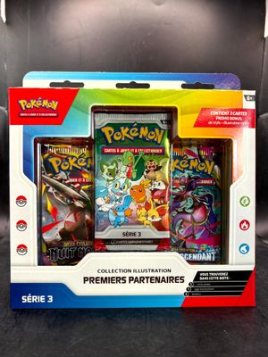 two pokemon cards are in a box on a table
