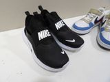 three pairs of shoes that are sitting on a table