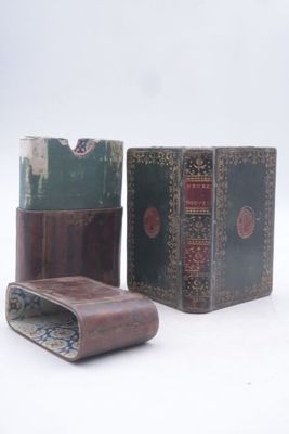 three books sitting next to each other on a white surface