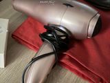 a hair dryer sitting on top of a table next to a pair of shoes