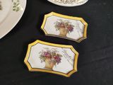 three plates that have flowers on them on a table