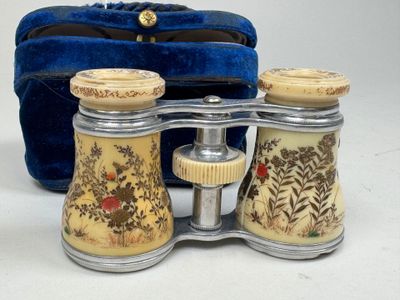 a pair of binoculars sitting next to a blue bag