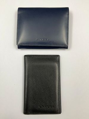 a black wallet and a blue wallet sitting on top of each other