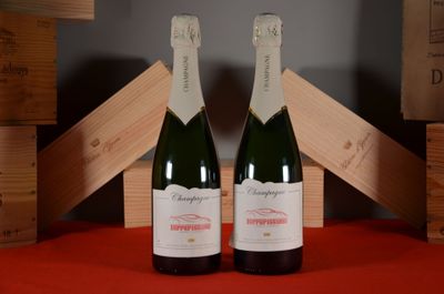 two bottles of champagne sitting next to each other on a table