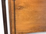 a wooden bed with a metal frame and a wooden headboard