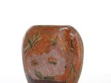 a vase with a flower design on it on a white surface