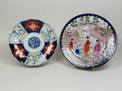 pair of japanese plates with figures and flowers on them
