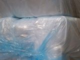 a pile of plastic bags sitting on top of a cardboard box