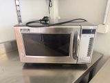 a microwave sitting on top of a stainless steel counter