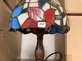 a lamp that is sitting on a table next to boxes