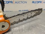 a chainsaw sitting on top of a table in front of a sign