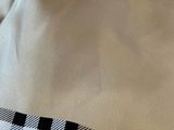 a close up of a white shirt with a black and white checkered tie