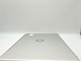 the back of a laptop computer sitting on top of a white table