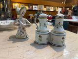 three ceramic figurines sitting on a table in a store
