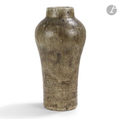 a brown vase that is sitting on a white surface