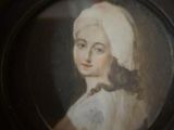 painting of a woman in a white dress with a cat on her shoulder