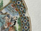 a plate with a picture of a woman and birds on it