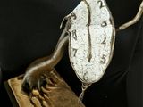 bronze sculpture of a horse and a leaf on a black surface