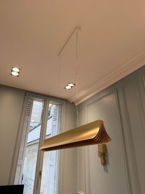 a lamp that is hanging from the ceiling in a room