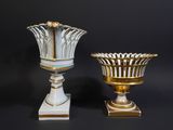 two vases sitting next to each other on a black background