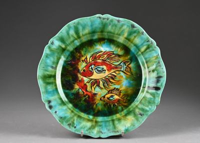 a green plate with a picture of a fish on it