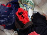 a pile of clothes that is on a couch
