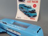 a blue toy bus and a magazine on a table