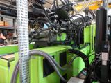 a green machine that is sitting in a factory
