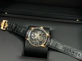 an image of a watch in a black box with a gold clasp