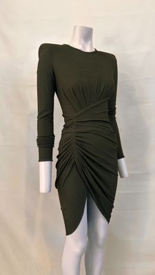 an image of a mannequin wearing a green dress on a white mannequin