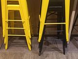 two yellow stools sitting next to each other on the floor